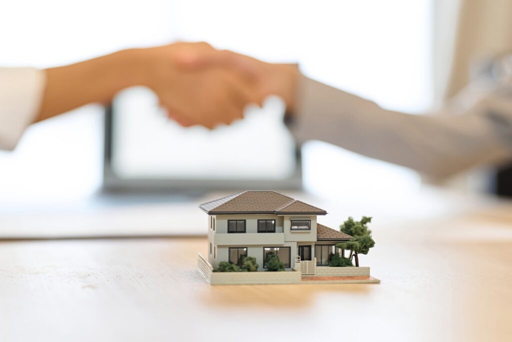 Real estate agent shaking hands after closing a deal.